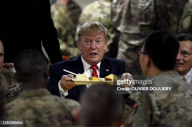 President Donald Trump serves Thanksgiving dinner to US troops at Bagram Air Field during a surprise visit on November 28, 2019 in Afghanistan.