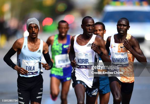 Tamirat Tola of Ethopia, Albert Korir of Kenya, and Geoffrey Kamworor of Kenya lead a pack of runners in the Men's Professional Division during the...