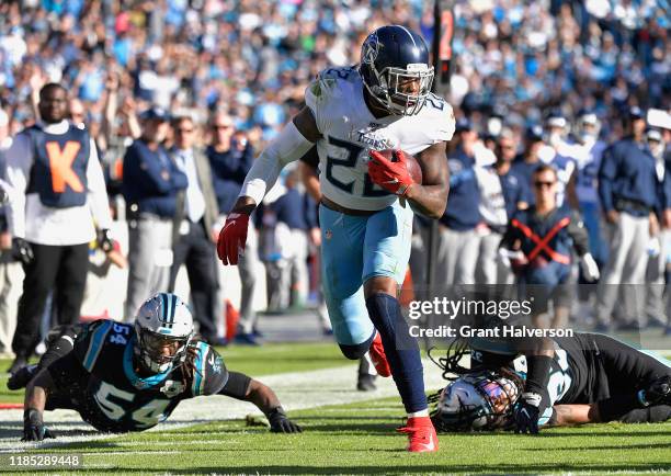 Derrick Henry of the Tennessee Titans breaks away from Shaq Thompson Tre Boston of the Carolina Panthers for a touchdown during the fourth quarter of...