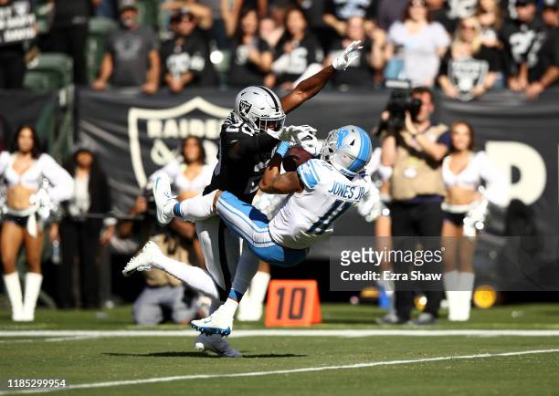 Marvin Jones Jr. #11 of the Detroit Lions catches the ball while he is covered by Daryl Worley of the Oakland Raiders at RingCentral Coliseum on...