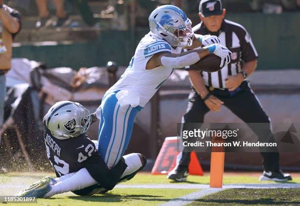 Kenny Golladay of the Detroit Lions scores a touchdown dragging Karl Joseph of the Oakland Raiders into the endzone during the second quarter of an...