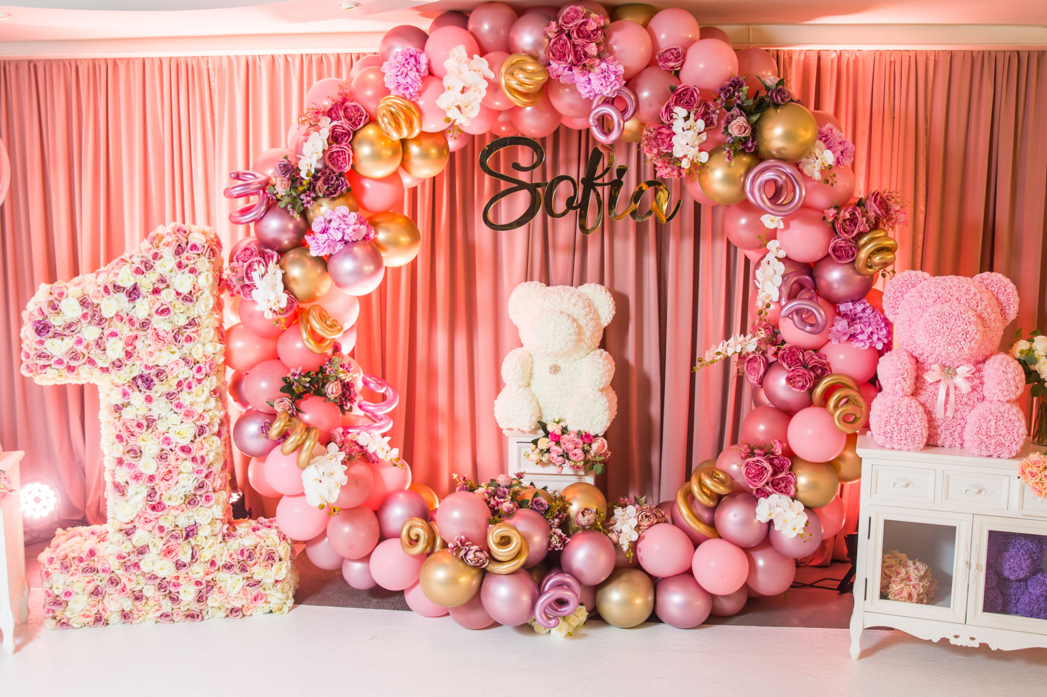 Decoration first birthday. The number 1 in the form of a pinata. Pink 1st birthday pinata on a background Decoration first birthday. The number 1 in the form of a pinata. Pink 1st birthday pinata on a background