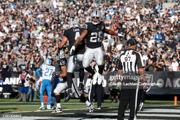 Josh Jacobs of the Oakland Raiders celebrates with quarterback Derek Carr after scoring a touchdown in the second quarter against the Detroit Lions...