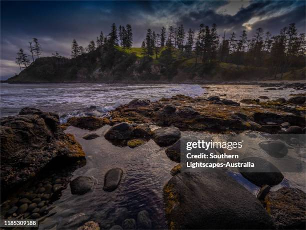 stormy light at cresswell's bay on norfolk island, south pacific. - cresswell stock pictures, royalty-free photos & images