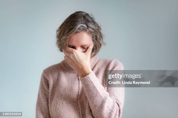 portrait of a mature woman - woman head in hands sad stock pictures, royalty-free photos & images