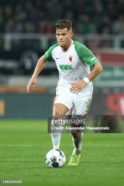 Florian Niederlechner of Augsburg runs with the ball during the Bundesliga match between FC Augsburg and FC Schalke 04 at WWK-Arena on November 03,...