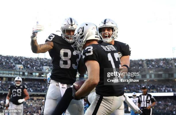 Hunter Renfrow of the Oakland Raiders is congratulated by Derek Carr and Darren Waller after he caught the winning touchdown pass against the Detroit...