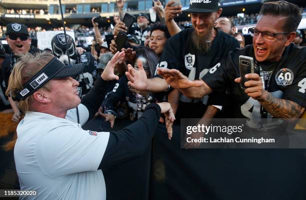 Head coach Jon Gruden of the Oakland Raiders celebrates with fans after a win against the Detroit Lions at RingCentral Coliseum on November 03, 2019...