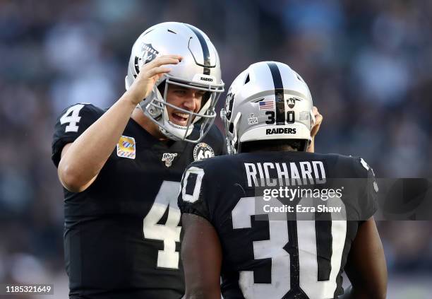 Derek Carr congratulates Jalen Richard of the Oakland Raiders after he caught a pass in the fourth quarter that set up the winning touchdown against...