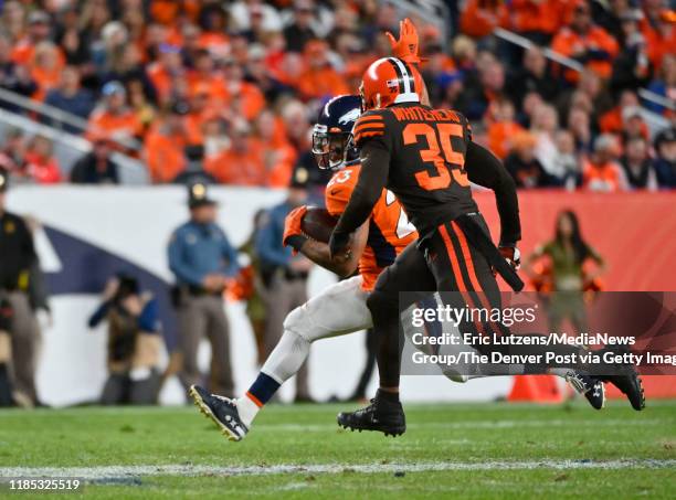 Denver Broncos running back Devontae Booker gets chased down by Cleveland Browns defensive back Jermaine Whitehead during the fourth quarter of the...