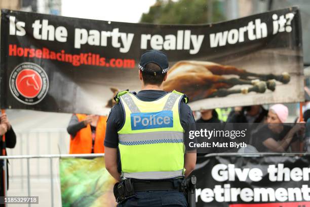 Police stand guard as horse activists protest during the 2019 Melbourne Cup Parade on November 04, 2019 in Melbourne, Australia.