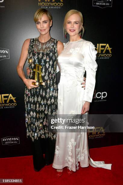 Charlize Theron , winner of the Hollywood Career Achievement Award and Nicole Kidman pose in the press room during the 23rd Annual Hollywood Film...