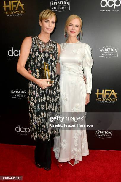 Charlize Theron , winner of the Hollywood Career Achievement Award and Nicole Kidman pose in the press room during the 23rd Annual Hollywood Film...