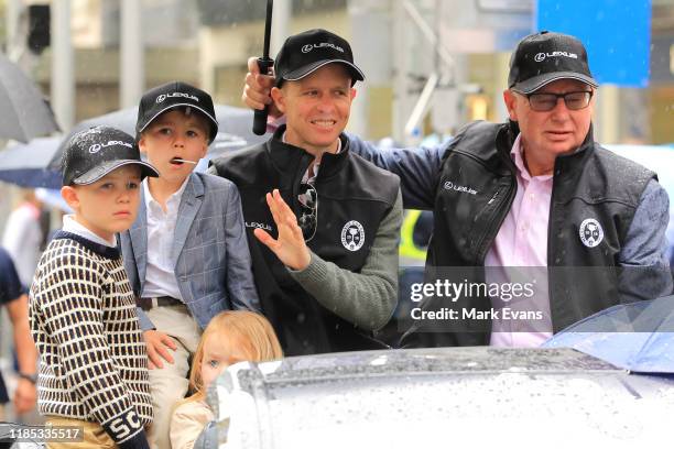 Finche rider Kerrin McEvoy braves the rain with his kids during the 2019 Melbourne Cup Parade on November 04, 2019 in Melbourne, Australia.