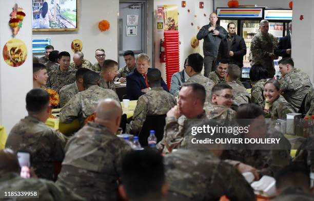 President Donald Trump shares a Thanksgiving dinner with US troops at Bagram Air Field during a surprise visit on November 28, 2019 in Afghanistan.