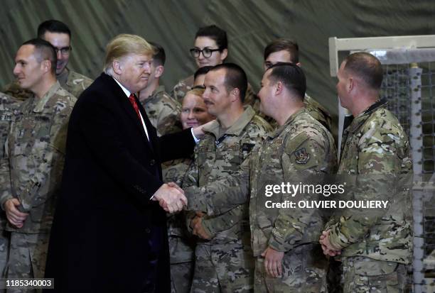 President Donald Trump greets soldiers after speaking to the troops during a surprise Thanksgiving day visit at Bagram Air Field, on November 28,...