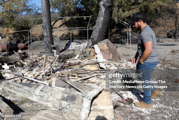 Jesus Gonzalez looks at the remains of his home that was destroyed by the Kincade Fire along Geyserville Road in Geyserville, Calif., on Thursday,...