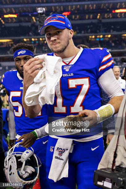 Josh Allen of the Buffalo Bills eats a turkey leg while he walks off the field after a game on Thanksgiving Day against the Dallas Cowboys at NRG...