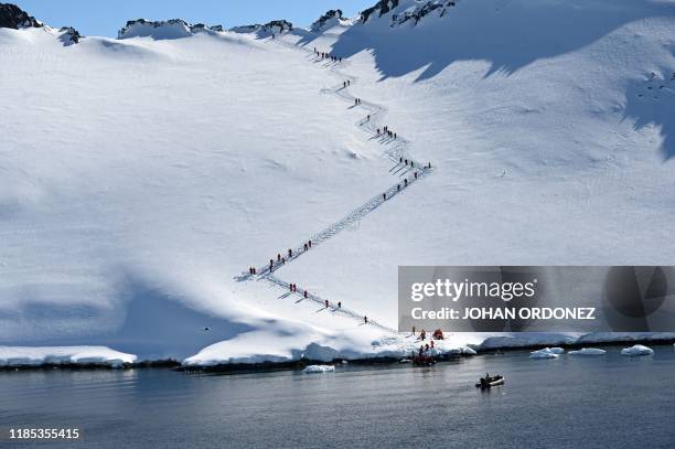 Tourists visit Orne Harbur in South Shetland Islands, Antarctica on November 08, 2019.