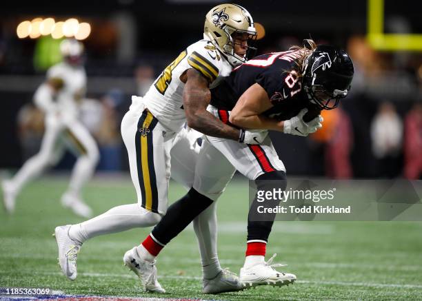 Jaeden Graham of the Atlanta Falcons is tackled by Vonn Bell of the New Orleans Saints during the second half of an NFL game at Mercedes-Benz Stadium...