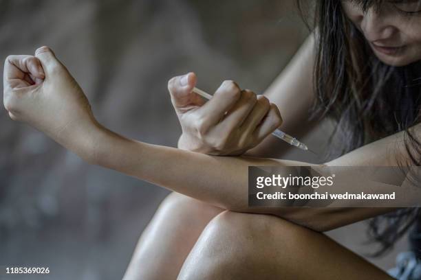 female junkie with syringe doing an injection dose - doping pills stock pictures, royalty-free photos & images