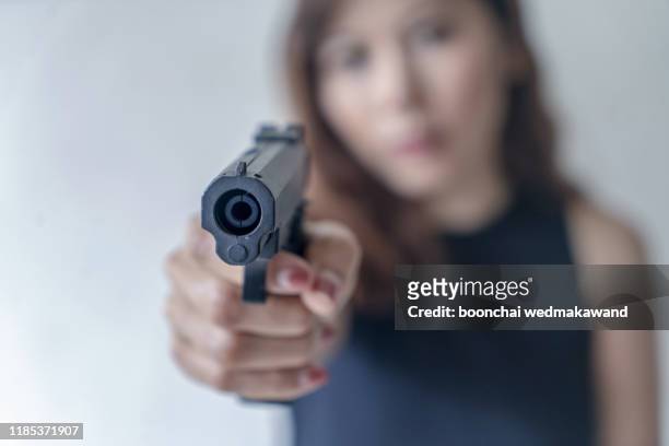 the girl aimed the gun - female hairy arms stock pictures, royalty-free photos & images