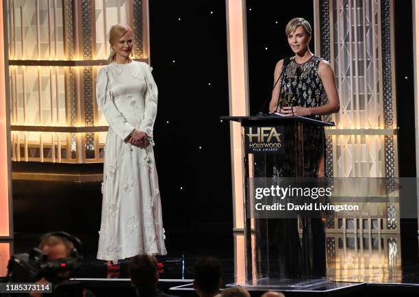 Nicole Kidman presents Charlize Theron with the Hollywood Career Achievement Award onstage during the 23rd Annual Hollywood Film Awards show at The...