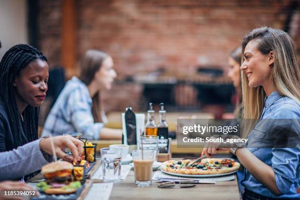 ladies sitting outdoors in restaurant - restaurant women friends lunch stock pictures, royalty-free photos & images