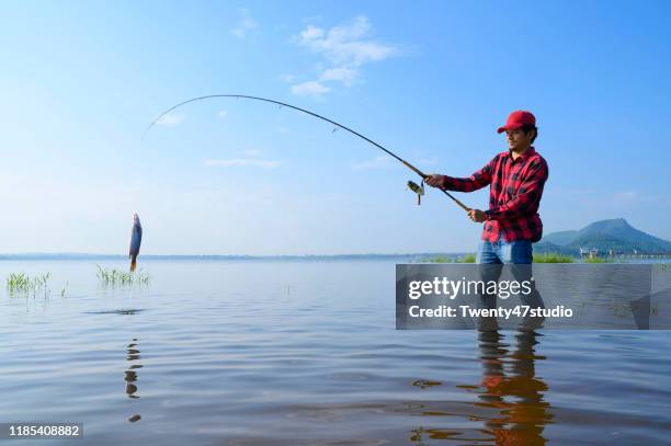 Man Getting Fish Guy Catching Fish Photos and Premium High Res Pictures - Getty Images