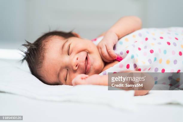 smiling newborn baby girl - smiling baby stock pictures, royalty-free photos & images