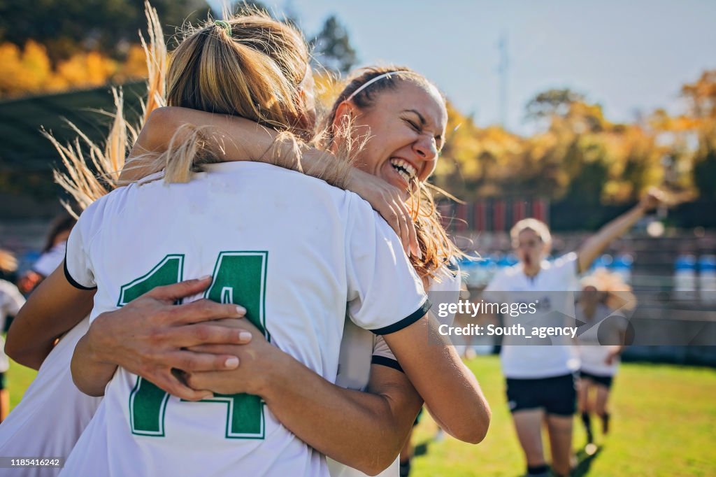 Girls soccer team celebrating victory