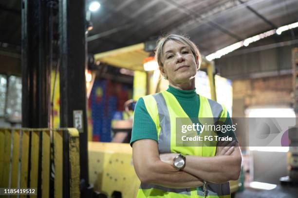 portrait of leader woman at warehouse - ware house worker forklift stock pictures, royalty-free photos & images