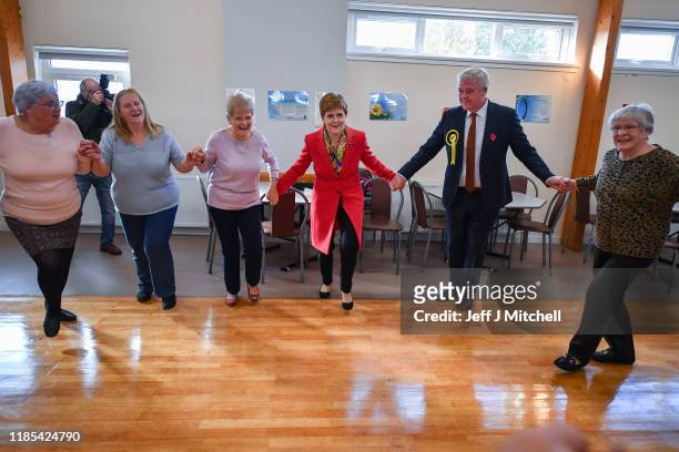 First Minister Nicola Sturgeon takes part in country dancing as she meets with staff and service users at Lochside Community Centre on November 4,...