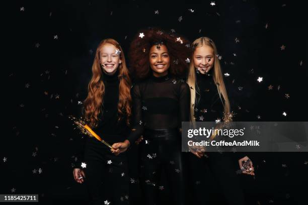 three happy young girls celebrates new year - girl band stock pictures, royalty-free photos & images