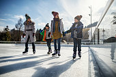 Family enjoying ice-skating together