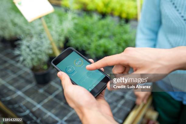 keeping a check on plants using a mobile app - application modernization stock-fotos und bilder