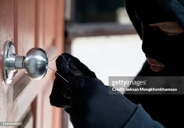 burglar using special tools to break in a house - broken door stock-fotos und bilder