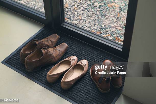 shoes by door - bruine schoen stockfoto's en -beelden