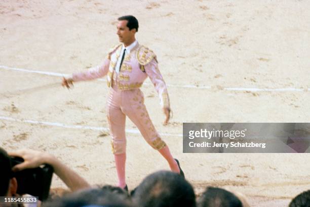 Spanish bullfighter Luis Miguel Dominguin presents his espada in front of a crowd in Arles Amphitheater, Arles, France, 1959.
