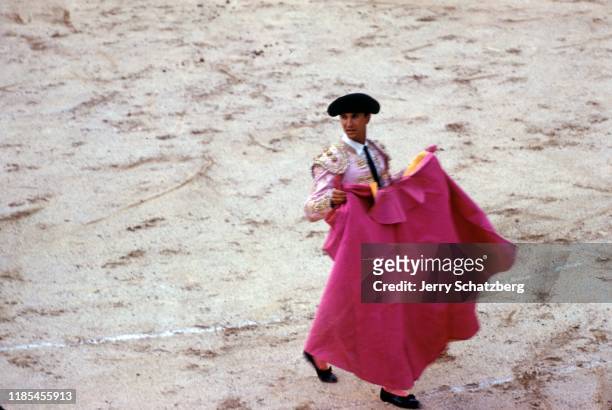 View of Spanish bullfighter Luis Miguel Dominguin with his capote de brega as he stands in Arles Amphitheater, Arles, France, 1959.