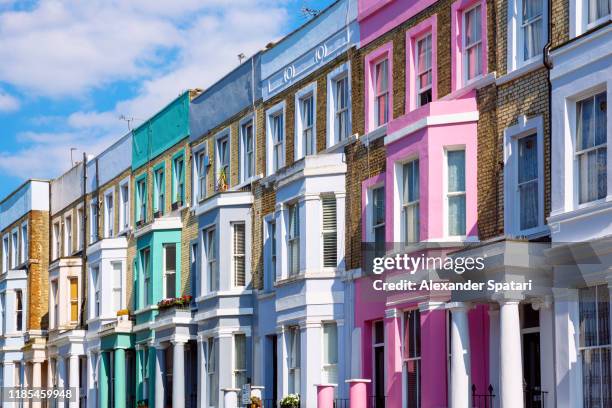 multicolored vibrant row houses in notting hill, london, uk - portobello road stockfoto's en -beelden