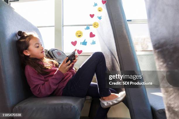 preteen girl using social media while on school bus - facebook like stock pictures, royalty-free photos & images