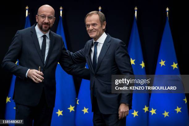 Outgoing European Council President Donald Tusk stands as newly appointed European Council President Charles Michel holds the presidency ceremonial...