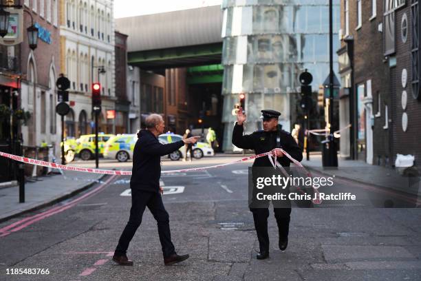 Members of the public are held behind a police cordon near London Bridge train station after reports of shots being fired on London Bridge on...