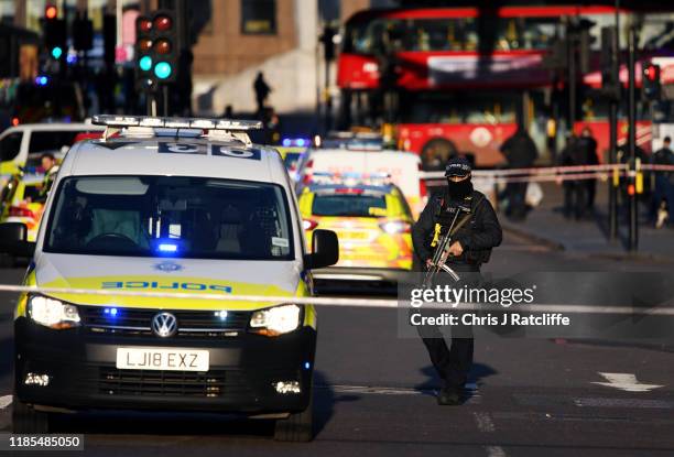 Metropolitan Police Armed Response officer stands guard near Borough Market after a number of people are believed to have been injured after a...