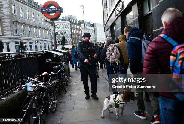 Metropolitan Police officer with a sniffer dog patrols near Borough Market after a number of people are believed to have been injured after a...