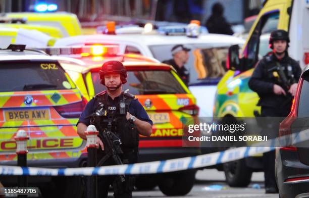 Armed police stand guard near The Monument in London, on November 29, 2019 after reports of shots being fired on London Bridge. - The Metropolitan...