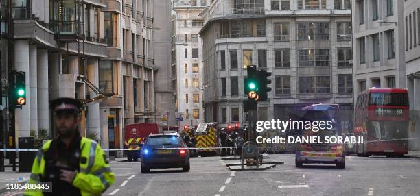 Police and emergency vechiles gather near Leadenhall in London, on November 29, 2019 after reports of shots being fired on London Bridge. - A man...