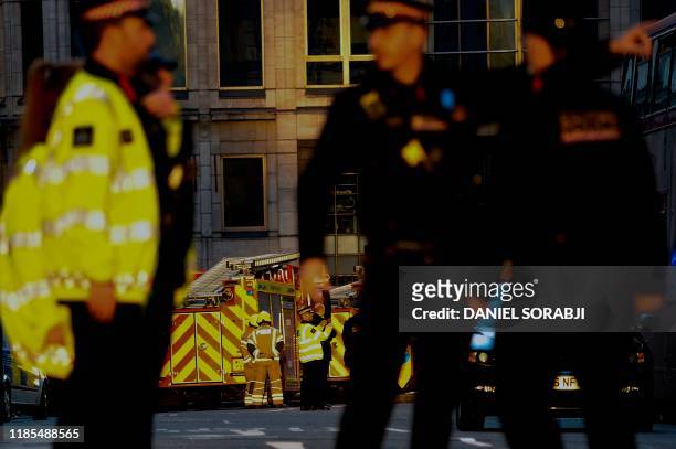 Police and emergency vechiles gather near London Bridge in London, on November 29, 2019 after reports of shots being fired on London Bridge. - A man...