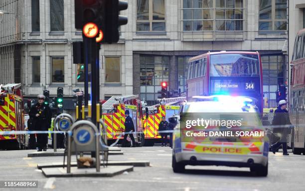 Police and emergency vechiles gather near London Bridge in London, on November 29, 2019 after reports of shots being fired on London Bridge. - A man...
